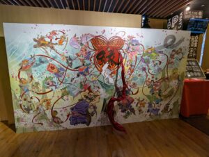 The Okami 20th anniversary key artwork is beautifully displayed at the entrance with an added 3D element as the sash jumps right out of the art.
